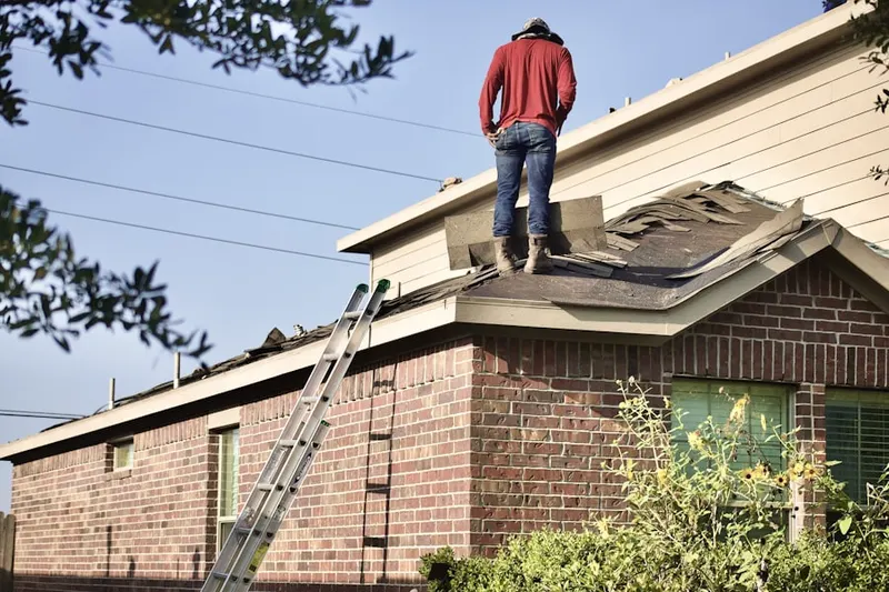 Professional roofer working on a residential roof in Fort Stockton